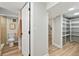 Open hallway with wood floors, leads to bathroom and storage shelves, offering ample space and modern design at 2731 W 42Nd Ave, Denver, CO 80211