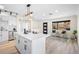 Bright kitchen with a large island, modern lighting, white cabinets, and a view to the outside at 2731 W 42Nd Ave, Denver, CO 80211