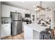 Modern kitchen featuring stainless steel appliances, white cabinets, and a large island at 2731 W 42Nd Ave, Denver, CO 80211