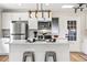 Modern kitchen with stainless steel appliances, sleek white cabinetry, quartz countertops, and a convenient island at 2731 W 42Nd Ave, Denver, CO 80211