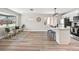 Open-concept living area with a kitchen island, stainless appliances, and stylish light fixtures at 2731 W 42Nd Ave, Denver, CO 80211