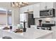 Kitchen with a large island, stainless steel appliances, modern lighting, and white countertops at 2731 W 42Nd Ave, Denver, CO 80211