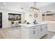 Bright kitchen with a large island, modern lighting, white cabinets, and a view to the outside at 2731 W 42Nd Ave, Denver, CO 80211
