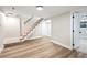 Open living area featuring carpeted stairs, fresh paint, wood flooring, and modern trim at 2731 W 42Nd Ave, Denver, CO 80211