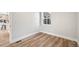 Empty room featuring hardwood floors, white walls, and large window bringing in natural light at 2731 W 42Nd Ave, Denver, CO 80211