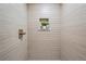 Tiled shower highlighting a modern fixture and in-wall shelf with greenery at 2731 W 42Nd Ave, Denver, CO 80211