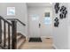 Bright entryway featuring wood floors, white trim, and natural light at 2108 Chambers Rd, Brighton, CO 80601