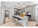 Open concept kitchen featuring an island with seating and modern appliances at 2108 Chambers Rd, Brighton, CO 80601