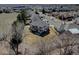 Aerial view of the home in a suburban neighborhood with mature trees at 5284 Taft Ct, Arvada, CO 80002