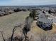 Wide aerial view of home with neighboring homes and an open field beyond at 5284 Taft Ct, Arvada, CO 80002