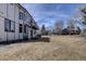 Well-maintained backyard with a large grassy area, mature trees, and a patio area, perfect for outdoor relaxation and entertaining at 5284 Taft Ct, Arvada, CO 80002