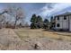 Grassy backyard with mature trees and gravel landscaping on a sunny day at 5284 Taft Ct, Arvada, CO 80002