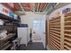 Basement storage room with shelves, unfinished ceiling and doorway into a carpeted bedroom at 5284 Taft Ct, Arvada, CO 80002