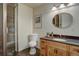 Bathroom featuring an updated vanity with stone countertops, bronze fixtures, framed mirror and glass enclosed shower at 5284 Taft Ct, Arvada, CO 80002