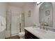 Bright bathroom features a vanity with marble counters, undermount sink, and a shower behind glass doors at 5284 Taft Ct, Arvada, CO 80002