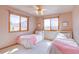 Bright bedroom featuring matching twin beds and large windows for natural light at 5284 Taft Ct, Arvada, CO 80002