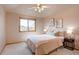 Cozy bedroom with a ceiling fan, window, and matching night stands at 5284 Taft Ct, Arvada, CO 80002