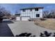 Spacious home featuring a multi-car garage and a long driveway, surrounded by landscaping and greenery at 5284 Taft Ct, Arvada, CO 80002