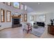 Spacious living room boasts a fireplace, tall ceilings with large windows, and light wood floors at 5284 Taft Ct, Arvada, CO 80002