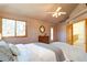 A brightly lit main bedroom with a ceiling fan and large picture window at 5284 Taft Ct, Arvada, CO 80002