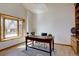 Bright office featuring a large window, hardwood floors, and a dark wood desk, ideal for a productive work environment at 5284 Taft Ct, Arvada, CO 80002
