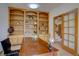 Inviting office space with custom built-in shelving, a classic desk, and ample storage at 5284 Taft Ct, Arvada, CO 80002