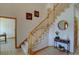 Open staircase with carpeted steps and a wooden banister, bathed in natural light, leading to the upper levels of the home at 5284 Taft Ct, Arvada, CO 80002
