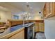 A cozy wet bar includes modern appliances, cabinets, stone countertop, and a beer tap at 5284 Taft Ct, Arvada, CO 80002