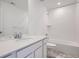 Well-lit bathroom featuring a tub-shower combo, single sink, and modern finishes at 7213 Waterleaf Trl, Littleton, CO 80125