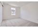 Empty bedroom features neutral paint and carpet, centered on one window at 7213 Waterleaf Trl, Littleton, CO 80125