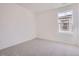 Empty bedroom features neutral paint and carpet, centered on one window at 7213 Waterleaf Trl, Littleton, CO 80125