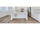 Open kitchen with a center island, stainless steel appliances, and modern finishes at 7213 Waterleaf Trl, Littleton, CO 80125