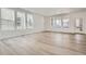 Bright and spacious living room with large windows and light hardwood flooring at 7213 Waterleaf Trl, Littleton, CO 80125