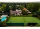 The expansive yard includes a tennis court, pool, patio, and lush landscaping with mature trees at 6211 E Orchard Dr, Greenwood Village, CO 80111