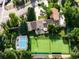 Expansive property showcasing a pool, tennis court, and beautifully landscaped grounds from an aerial perspective at 6211 E Orchard Dr, Greenwood Village, CO 80111