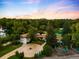 Aerial view of the home, with its circular driveway, mature trees, tennis court and other lush landscaping at 6211 E Orchard Dr, Greenwood Village, CO 80111