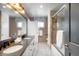 Stylish bathroom with double sinks, granite countertops, tiled floors, and a glass shower at 6211 E Orchard Dr, Greenwood Village, CO 80111