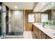 Modern bathroom featuring a glass-enclosed shower, vanity, and neutral color palette at 6211 E Orchard Dr, Greenwood Village, CO 80111