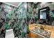 Stylish half bath with decorative wallpaper and a unique basin sink at 6211 E Orchard Dr, Greenwood Village, CO 80111