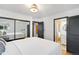 Inviting bedroom with mirrored closet doors, and a doorway to an ensuite bathroom at 6211 E Orchard Dr, Greenwood Village, CO 80111