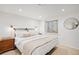 Minimal bedroom featuring a queen bed, wooden nightstand, and a neutral color scheme at 6211 E Orchard Dr, Greenwood Village, CO 80111