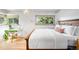 Comfortable bedroom featuring a wooden bed frame, bright windows, and a modern style at 6211 E Orchard Dr, Greenwood Village, CO 80111