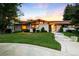 Beautifully landscaped ranch style home with unique architecture and a stone walkway leading to the front door at 6211 E Orchard Dr, Greenwood Village, CO 80111