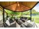 Relaxing covered gazebo with comfortable seating, perfect for enjoying the lush backyard and tennis court at 6211 E Orchard Dr, Greenwood Village, CO 80111