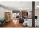 Spacious living room with hardwood floors, brick fireplace, and staircase access to upper level at 6211 E Orchard Dr, Greenwood Village, CO 80111