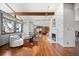 Spacious living room with hardwood floors, a cozy fireplace, neutral-toned walls and oversized windows at 6211 E Orchard Dr, Greenwood Village, CO 80111