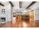 Large living area with hardwood floors and an open design that flows into the expansive kitchen, with an island and bar seating at 6211 E Orchard Dr, Greenwood Village, CO 80111