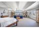 Spacious main bedroom featuring high ceilings, natural light, and decorative wall coverings at 6211 E Orchard Dr, Greenwood Village, CO 80111