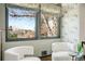 Cozy sitting area with natural light streaming through windows and views of the beautifully landscaped outdoors at 6211 E Orchard Dr, Greenwood Village, CO 80111