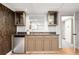 Basement wet bar area with stylish cabinets, countertop, and a compact refrigerator at 6211 E Orchard Dr, Greenwood Village, CO 80111